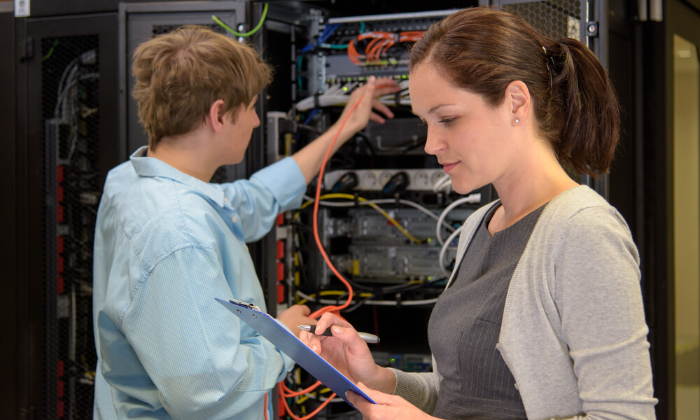 female IT professional in data center with colleague