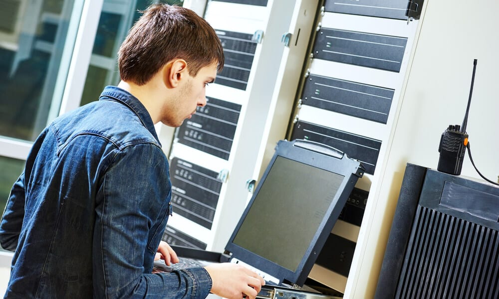 Man working at a server terminal.