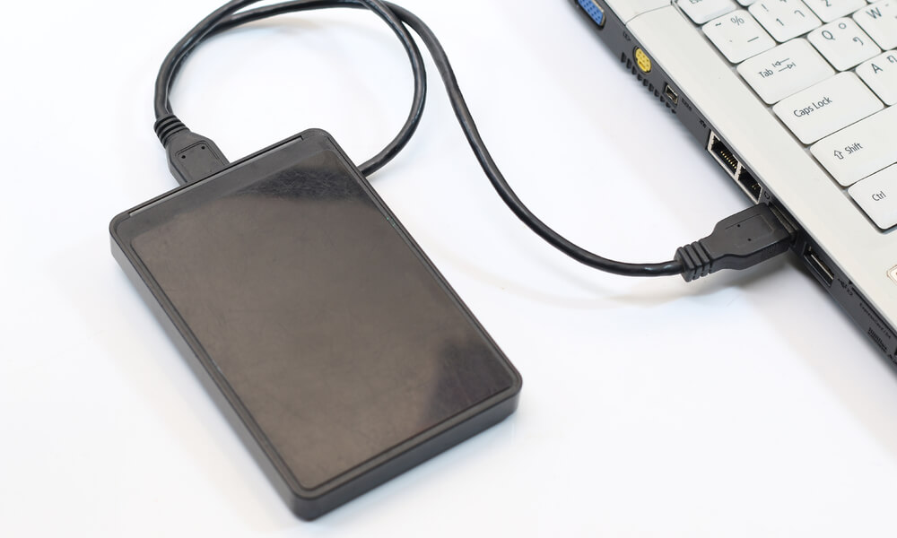 external hard drive connected to a laptop to show external backup solution