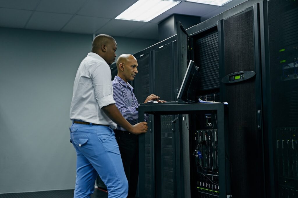 IT professionals working in server room to set up cloud pc tools for business