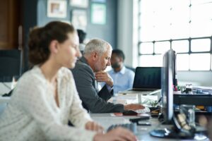 group of coworkers in office working on computers