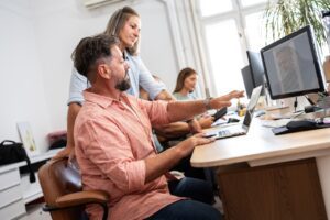 coworkers in office looking at their company's cybersecurity awareness program