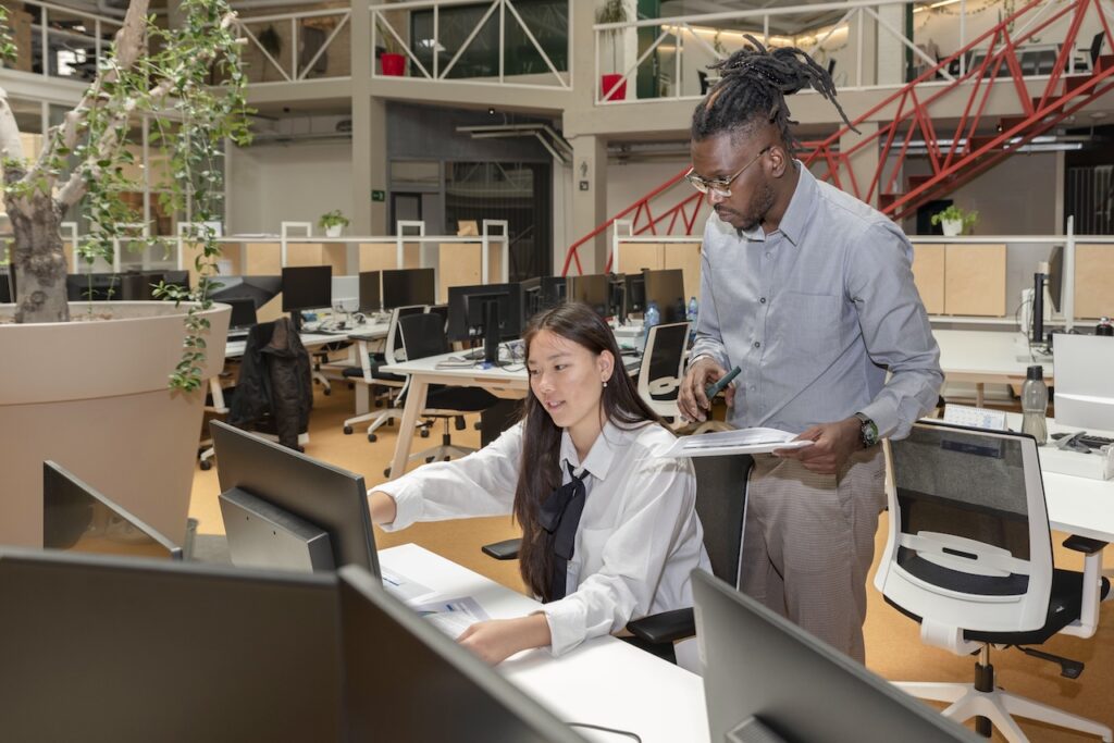 two coworkers working on a project in office space